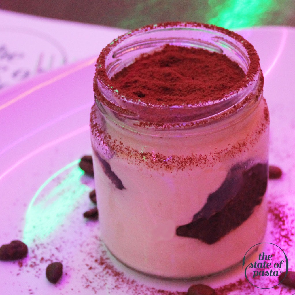 Homemade tiramisu made from scratch, featuring layers of rich mascarpone cream, espresso-soaked ladyfingers, and a dusting of cocoa powder.