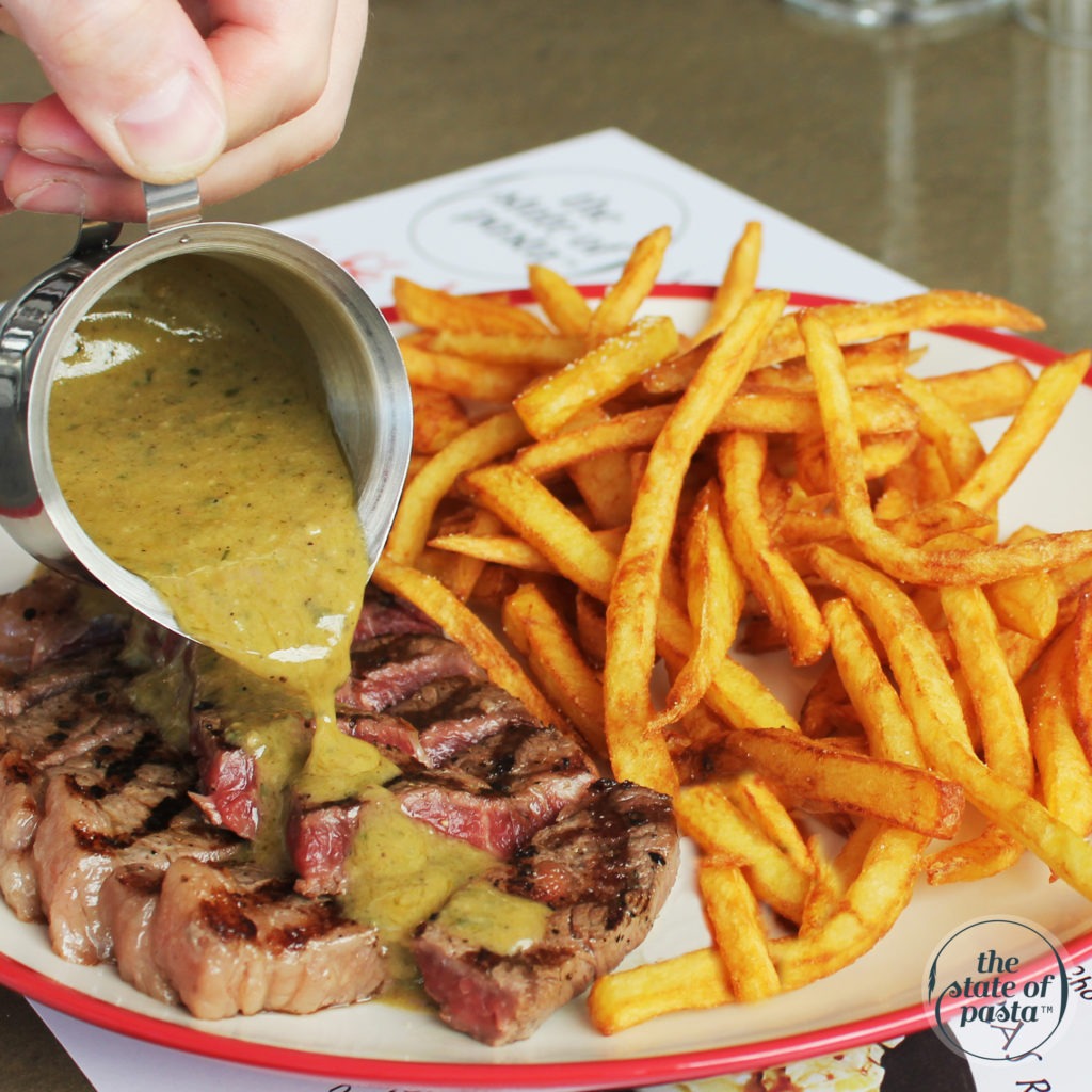 Black Angus ribeye steak cooked to your liking, served with crispy homemade French fries and a rich, flavorful Café de Paris sauce.